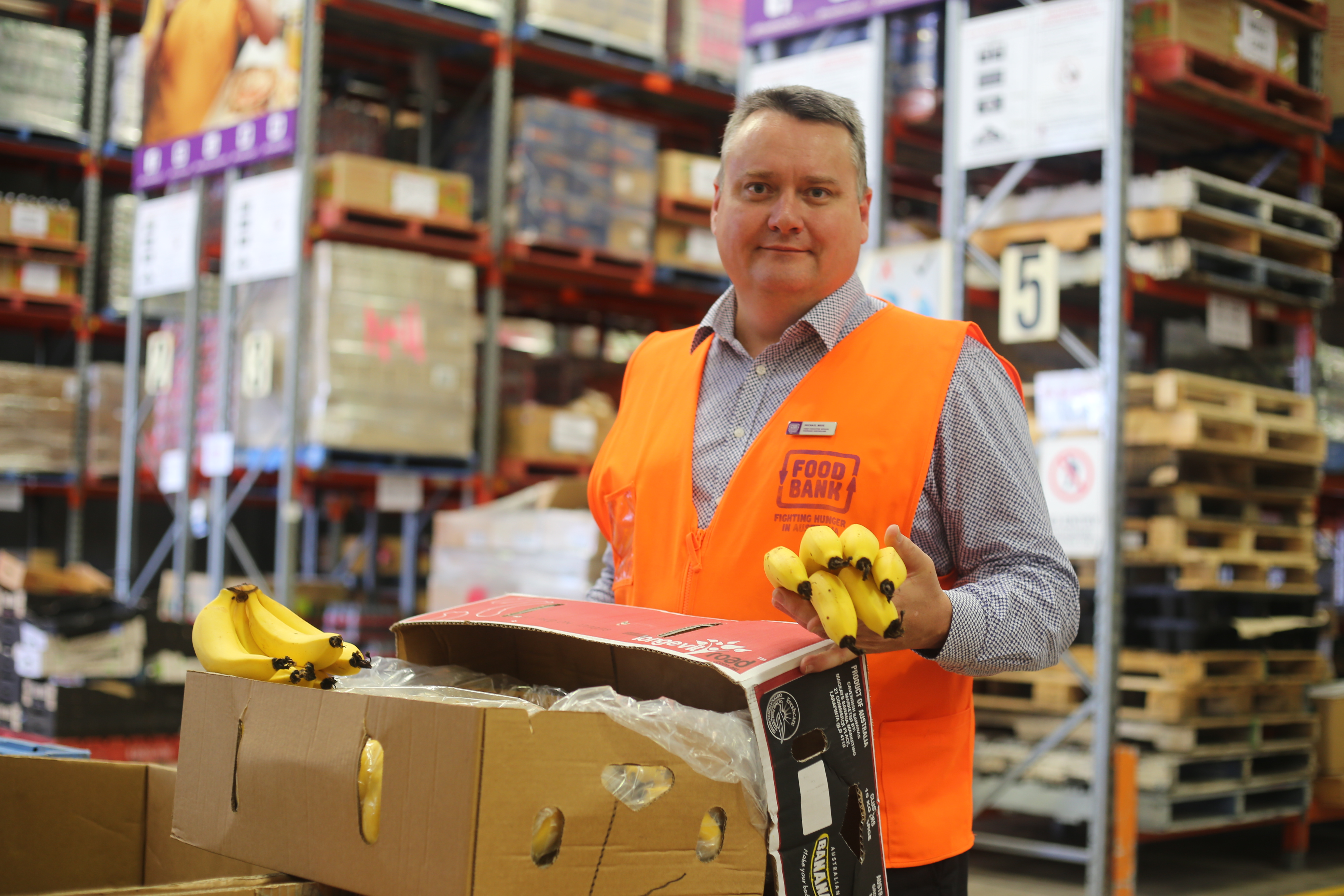 Foodbank Queensland CEO Michael Rose with some donated bananas.