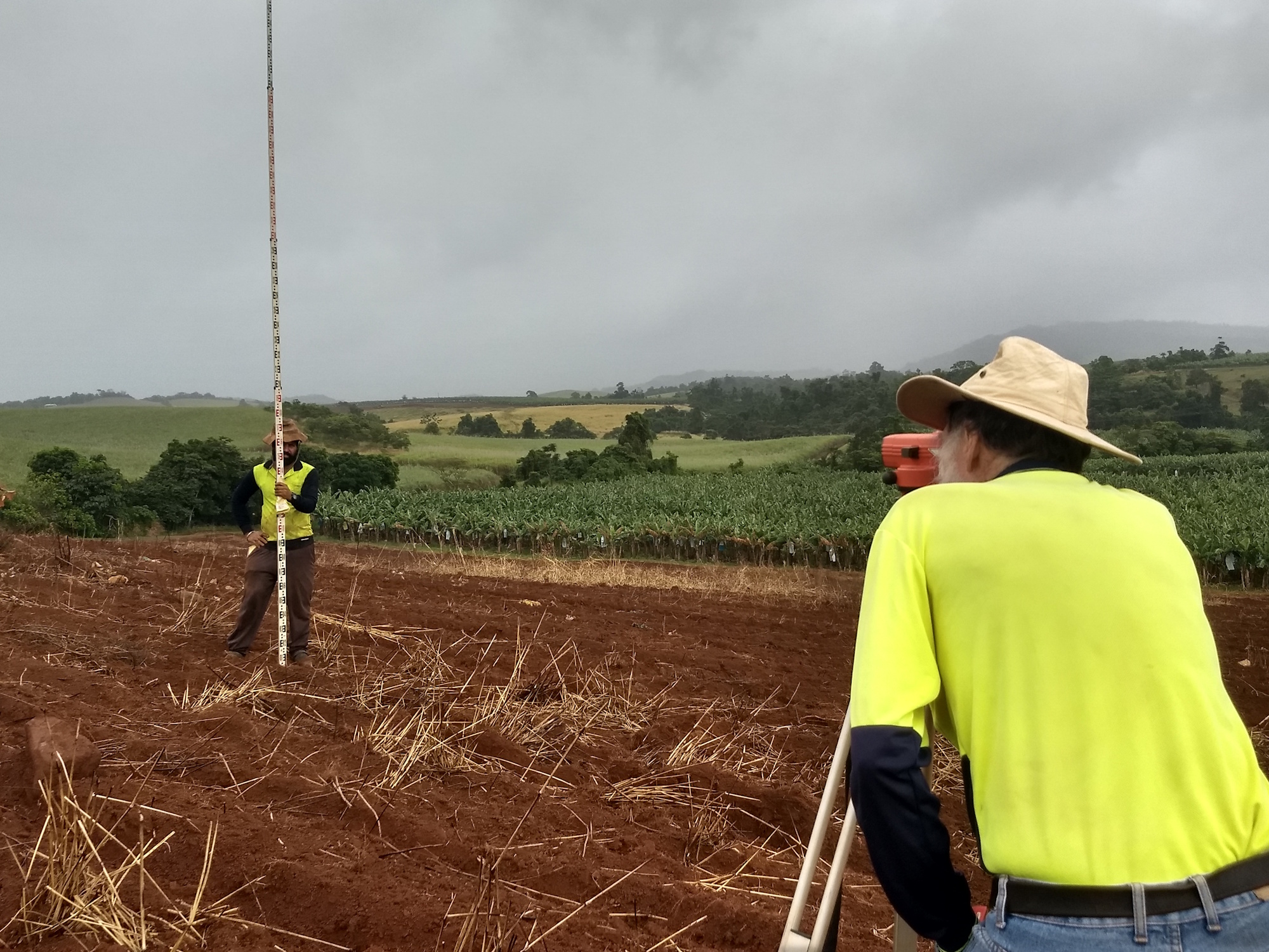 Grower Satinderjit Sing Gill works with Soil Conservationist Darryl Evans to design contours on his farm. This work was funded by the Reef Trust III program.